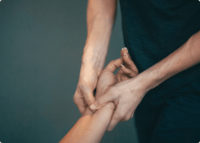 A Physio-Logic therapist working hands-on with a patient's wrist and forearm