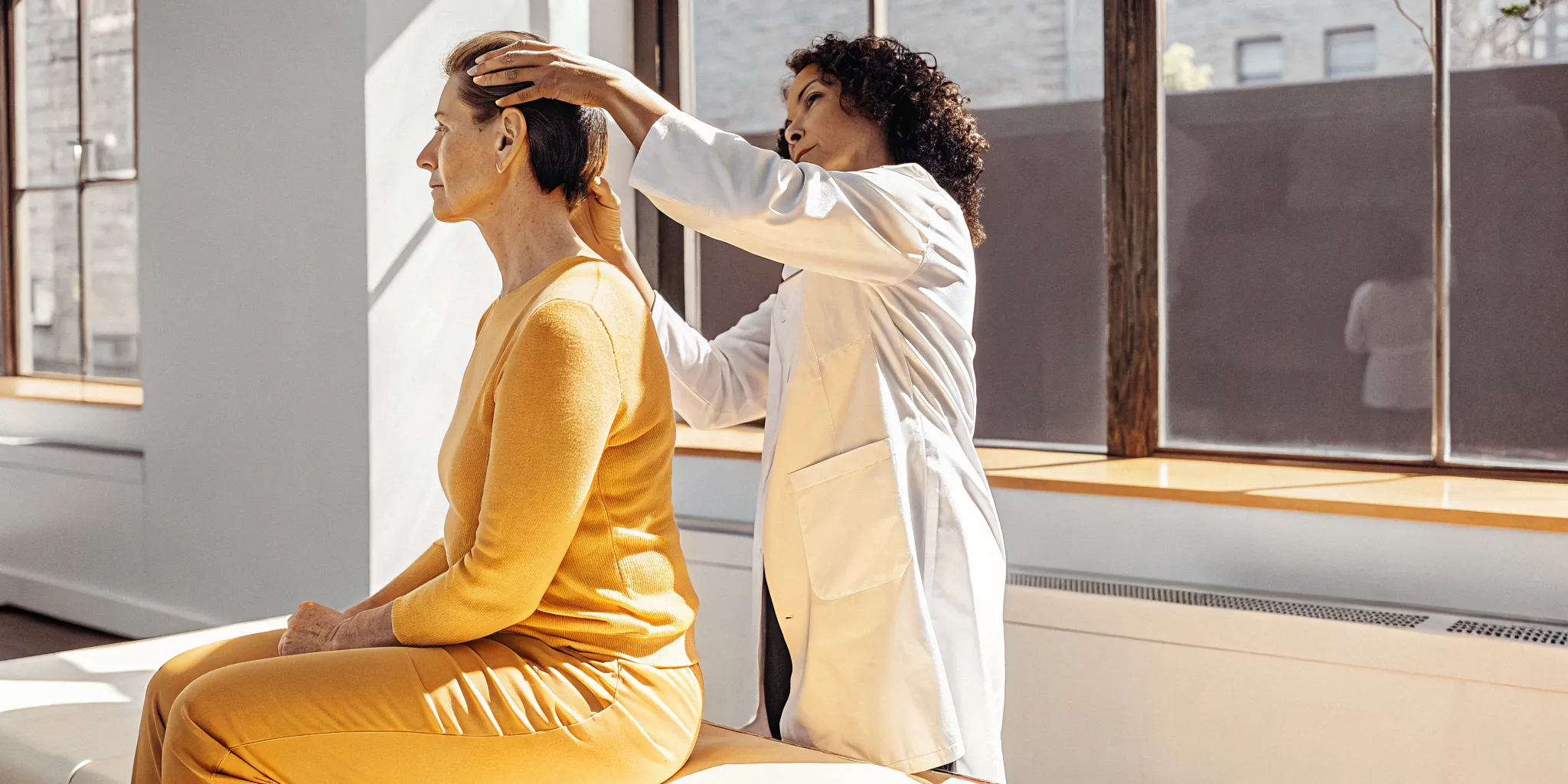 Chiropractor in Brooklyn NYC assessing a patient's shoulder movement