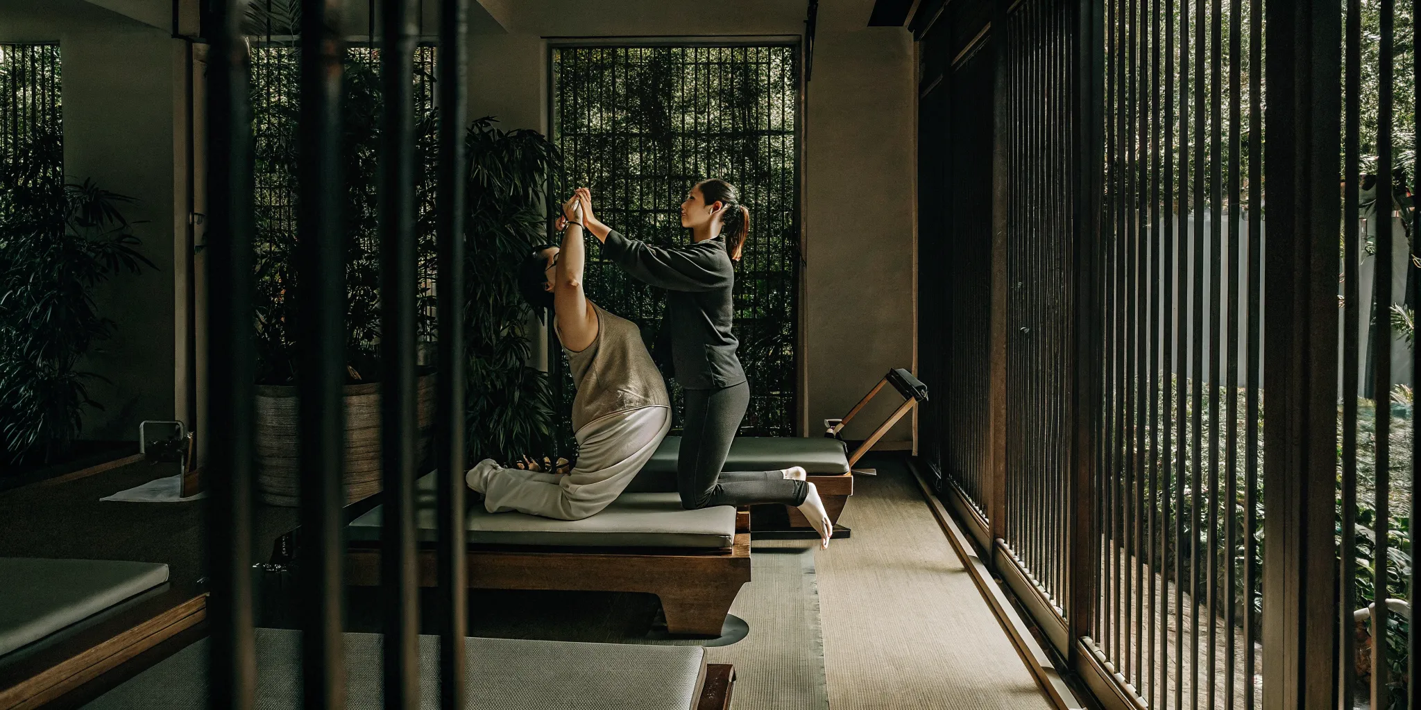 A physical therapist guiding a patient through a shoulder stretching exercise